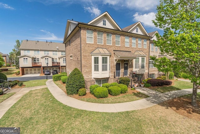 multi unit property featuring a front lawn and brick siding