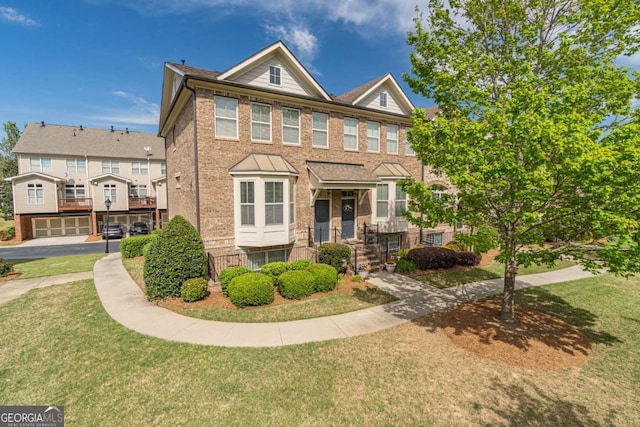 multi unit property with a front lawn and brick siding
