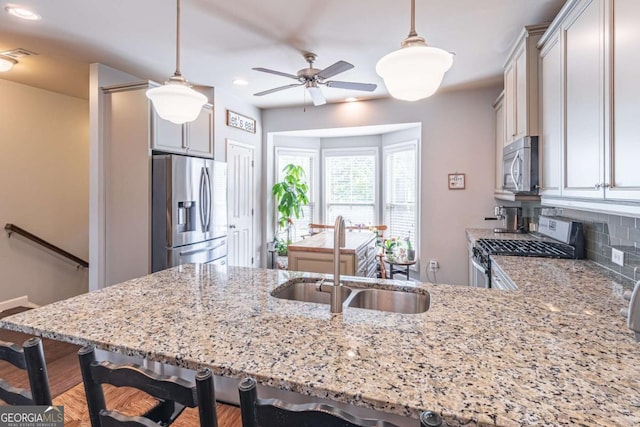 4236 Tacoma Trce, Suwanee, GA 30024 - kitchen with stainless steel appliances, a sink, light stone counters, a peninsula, and recessed lighting