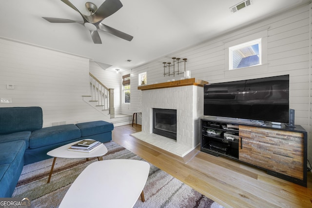 3278 Shakerley Park, Douglasville, GA 30135 - living room featuring stairway, wood finished floors, visible vents, a ceiling fan, and a fireplace