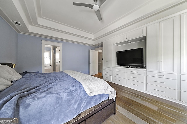3278 Shakerley Park, Douglasville, GA 30135 - bedroom with a raised ceiling, wood finished floors, visible vents, ceiling fan, and ensuite bathroom