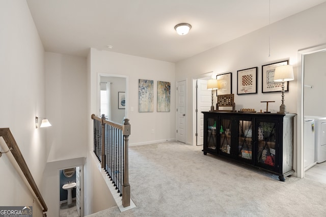 113 Silver Leaf Trce, Douglasville, GA 30134 - hall featuring washing machine and clothes dryer, carpet flooring, an upstairs landing, and baseboards