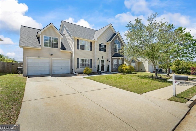 view of front of house featuring concrete driveway, an attached garage, fence, and a front yard