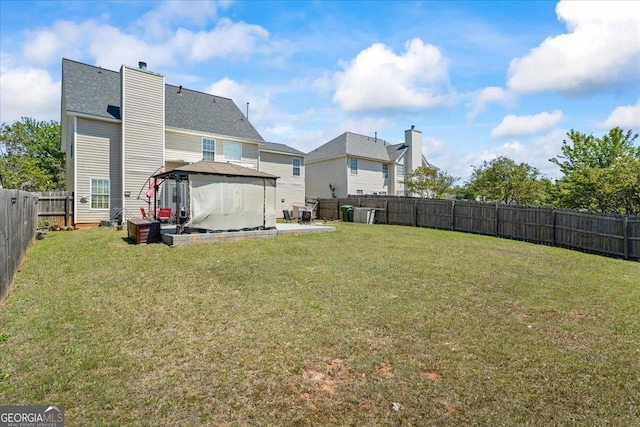 view of yard featuring a fenced backyard, a gazebo, and a patio area