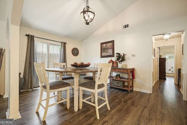 dining space with dark wood-style flooring, a healthy amount of sunlight, visible vents, and baseboards