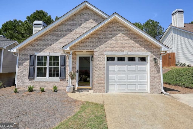 view of front of property featuring a chimney, driveway, and a garage