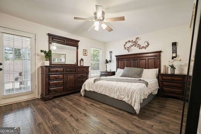 bedroom with multiple windows, access to exterior, a ceiling fan, and dark wood-style flooring