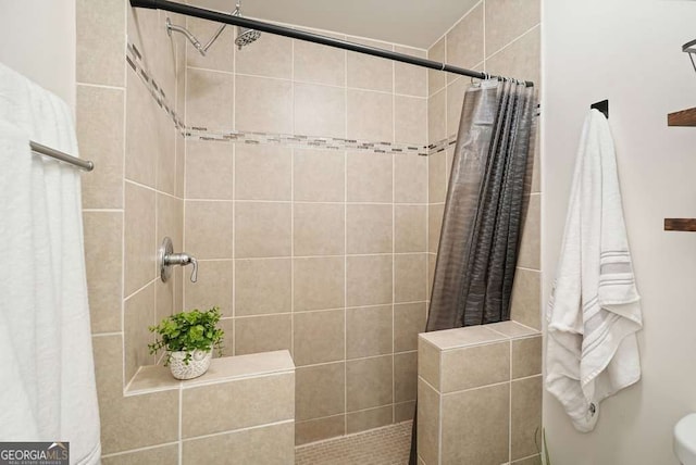 full bathroom with tiled shower