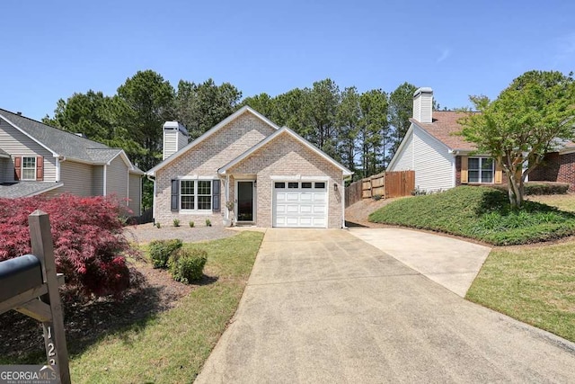 ranch-style home with a chimney, fence, concrete driveway, an attached garage, and brick siding