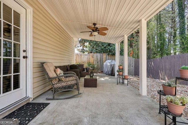 view of patio / terrace with a fenced backyard, outdoor lounge area, a ceiling fan, and grilling area