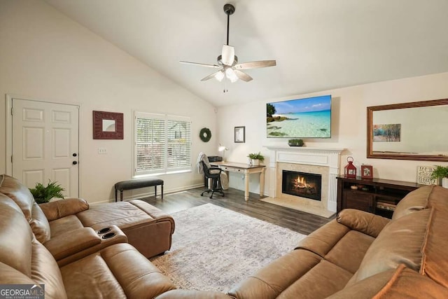 living room featuring high vaulted ceiling, a ceiling fan, wood finished floors, a high end fireplace, and baseboards
