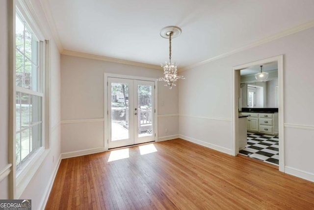 490 Mcwhorter Dr, Athens, GA 30606 - empty room with french doors, light wood-type flooring, a chandelier, and ornamental molding
