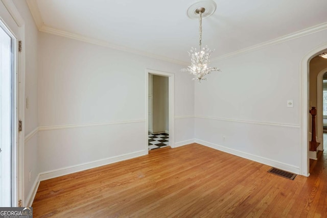 490 Mcwhorter Dr, Athens, GA 30606 - unfurnished dining area featuring arched walkways, light wood-type flooring, ornamental molding, and a chandelier