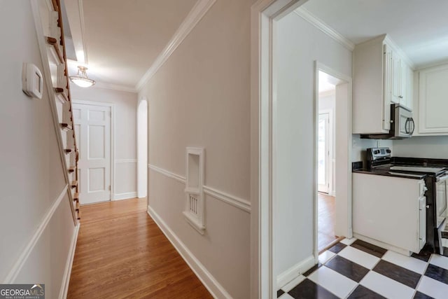 490 Mcwhorter Dr, Athens, GA 30606 - hallway with crown molding, arched walkways, light wood finished floors, and stairway