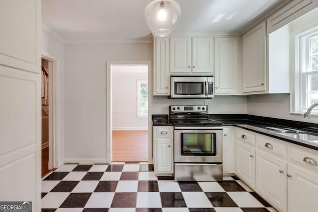490 Mcwhorter Dr, Athens, GA 30606 - kitchen with stainless steel appliances, dark floors, plenty of natural light, dark countertops, and ornamental molding