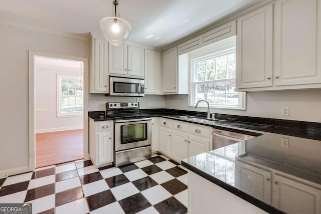 490 Mcwhorter Dr, Athens, GA 30606 - kitchen with appliances with stainless steel finishes, light flooring, crown molding, white cabinets, and decorative light fixtures