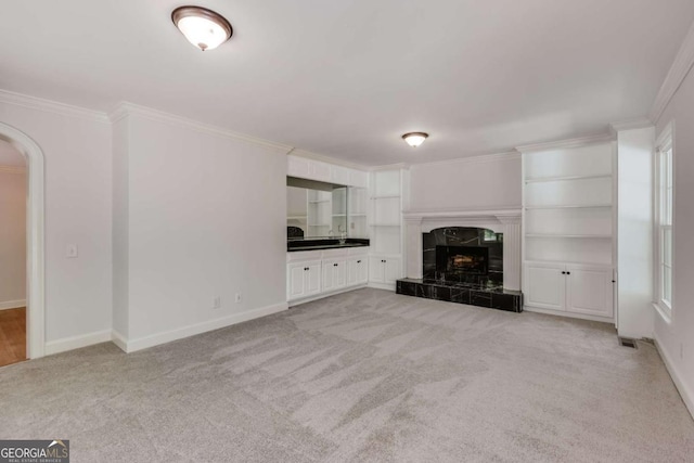 490 Mcwhorter Dr, Athens, GA 30606 - unfurnished living room with light colored carpet, crown molding, arched walkways, and a tile fireplace