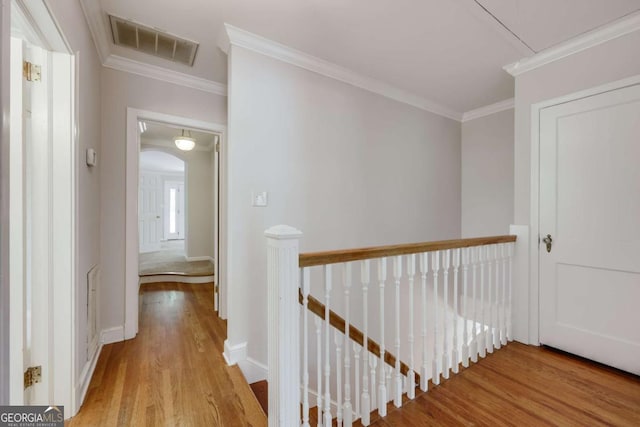 490 Mcwhorter Dr, Athens, GA 30606 - corridor featuring an upstairs landing, wood finished floors, crown molding, arched walkways, and attic access