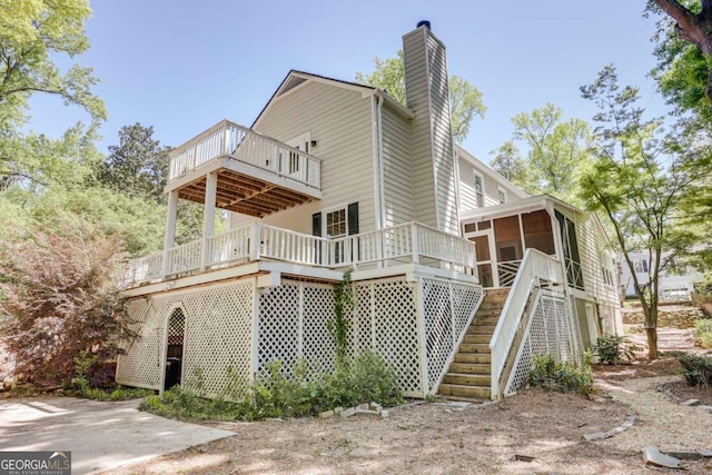 490 Mcwhorter Dr, Athens, GA 30606 - view of side of home with a sunroom, a chimney, a deck, and stairway