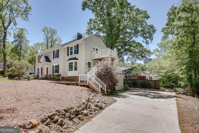 490 Mcwhorter Dr, Athens, GA 30606 - view of front facade featuring a chimney, a balcony, concrete driveway, and stairway