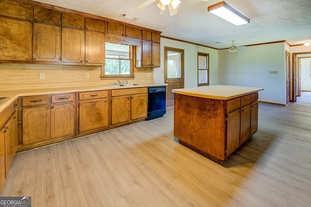 kitchen with light wood finished floors, ceiling fan, brown cabinetry, dishwasher, and ornamental molding