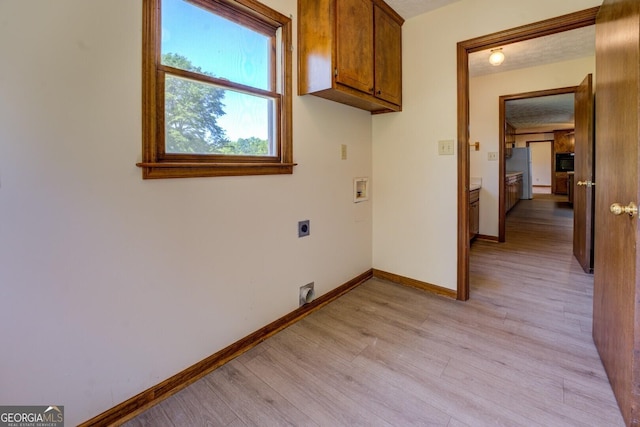 laundry room with light wood-style flooring, hookup for an electric dryer, baseboards, washer hookup, and cabinet space