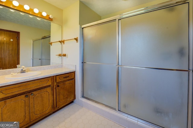 full bathroom featuring an enclosed shower, tile patterned floors, and vanity