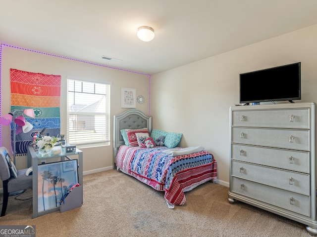 carpeted bedroom featuring baseboards
