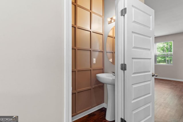 bathroom with wood finished floors and baseboards