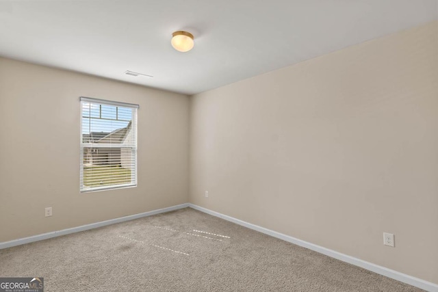 carpeted empty room with baseboards