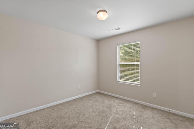 empty room with carpet floors and baseboards
