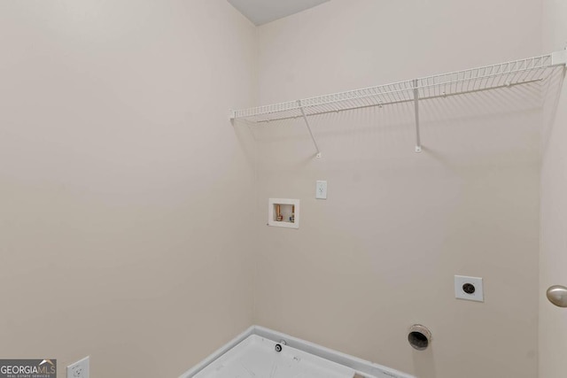 washroom with hookup for a washing machine, hookup for an electric dryer, and baseboards