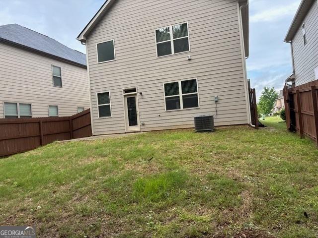 back of house featuring central AC unit