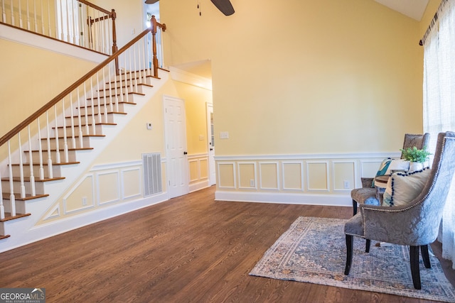 109 Trudie Ln, Macon, GA 31216 - living area with a ceiling fan, stairway, a towering ceiling, wood finished floors, and a wainscoted wall