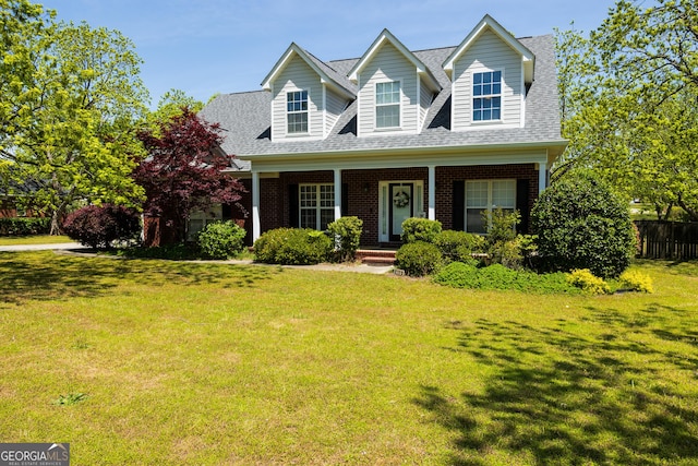 109 Trudie Ln, Macon, GA 31216 - cape cod house featuring roof with shingles, brick siding, and a porch