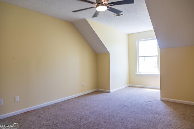109 Trudie Ln, Macon, GA 31216 - bonus room featuring ceiling fan, vaulted ceiling, carpet flooring, and a textured ceiling