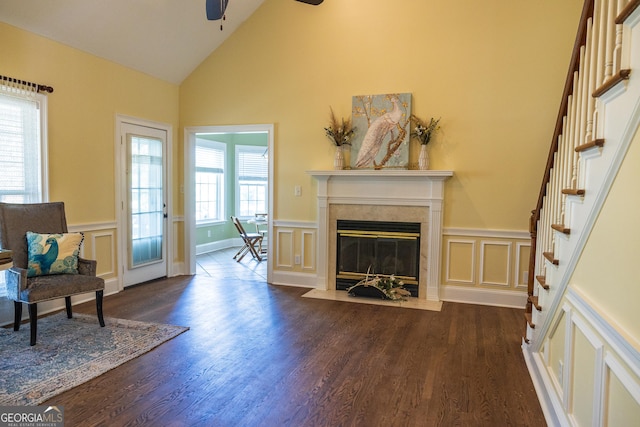 109 Trudie Ln, Macon, GA 31216 - living area with a decorative wall, a ceiling fan, dark wood-type flooring, a fireplace, and a wainscoted wall