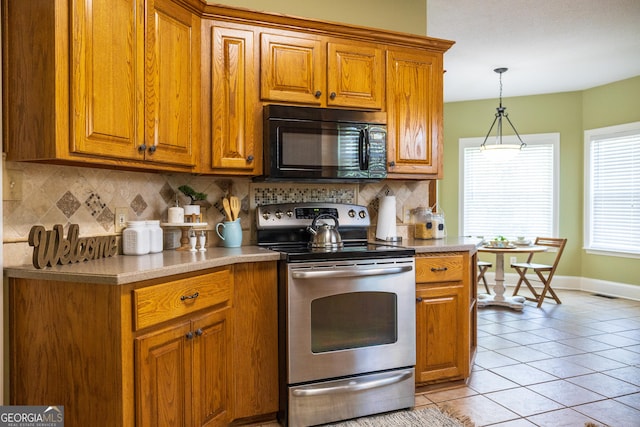 109 Trudie Ln, Macon, GA 31216 - kitchen featuring black microwave, electric range, brown cabinets, and tasteful backsplash