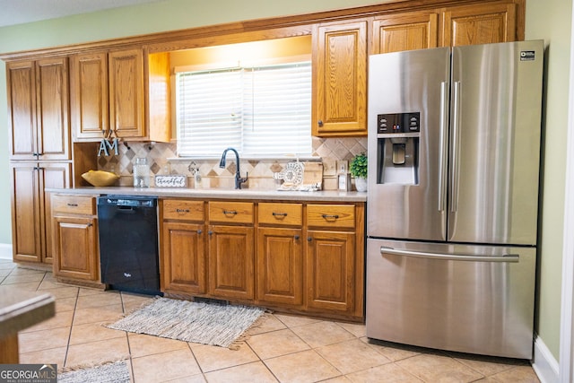 109 Trudie Ln, Macon, GA 31216 - kitchen featuring stainless steel fridge, dishwasher, and brown cabinetry