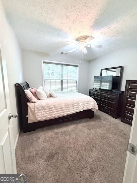 622 River Rock Cir, Jefferson, GA 30549 - bedroom featuring carpet floors, a textured ceiling, and ceiling fan