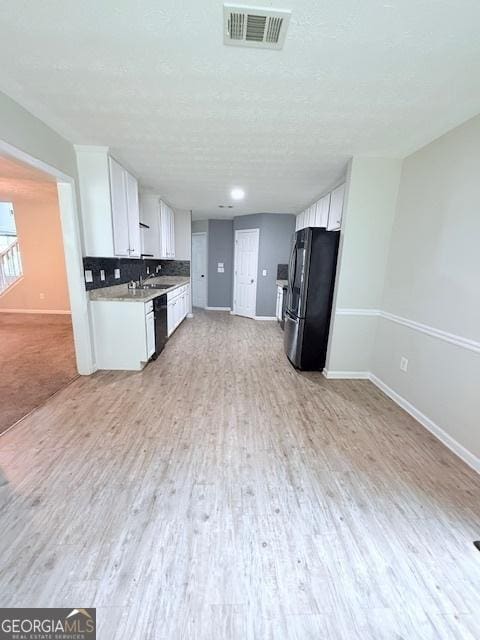 622 River Rock Cir, Jefferson, GA 30549 - kitchen featuring black appliances, baseboards, white cabinetry, open floor plan, and light countertops