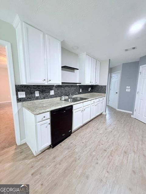 622 River Rock Cir, Jefferson, GA 30549 - kitchen with black dishwasher, a sink, white cabinetry, backsplash, and light wood finished floors