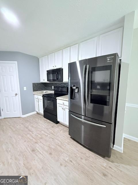 622 River Rock Cir, Jefferson, GA 30549 - kitchen featuring black appliances, white cabinets, light wood-style flooring, and baseboards