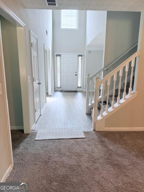 622 River Rock Cir, Jefferson, GA 30549 - foyer entrance featuring carpet, stairway, baseboards, and a towering ceiling