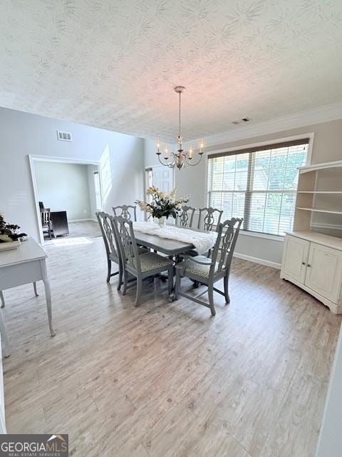 622 River Rock Cir, Jefferson, GA 30549 - dining space with a textured ceiling, light wood-style flooring, a chandelier, baseboards, and ornamental molding