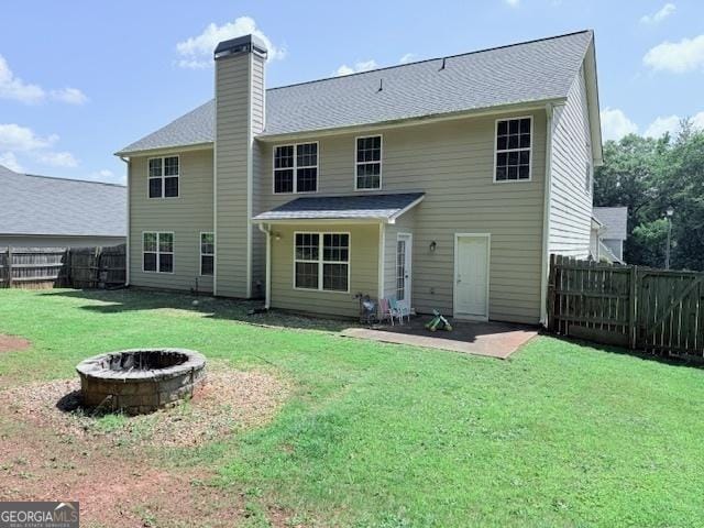 622 River Rock Cir, Jefferson, GA 30549 - rear view of house with a fire pit, a patio area, a chimney, and a shingled roof