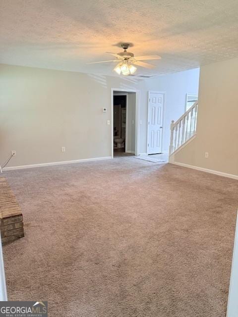 622 River Rock Cir, Jefferson, GA 30549 - unfurnished living room with a textured ceiling, ceiling fan, light colored carpet, and baseboards