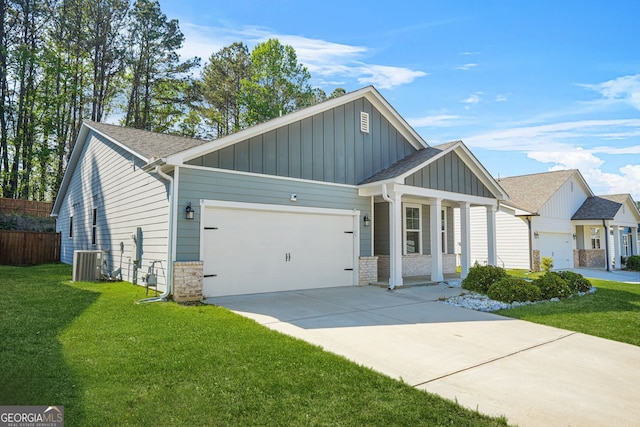 view of front of home with board and batten siding, an attached garage, a front yard, and driveway