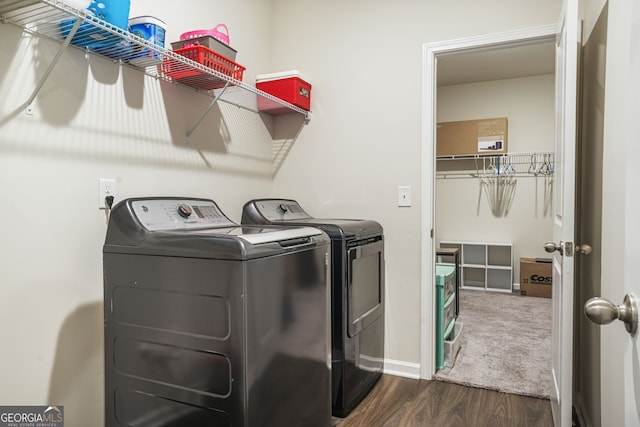 laundry room with baseboards, wood finished floors, washer and clothes dryer, and laundry area