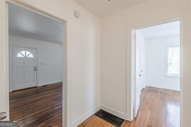 foyer featuring hardwood / wood-style floors and baseboards
